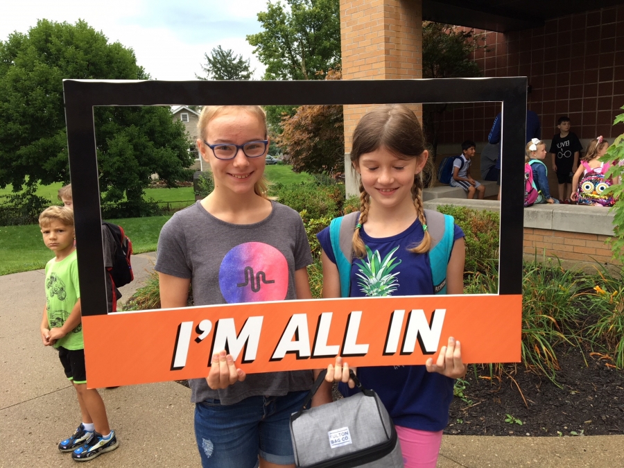 people holding a frame sign